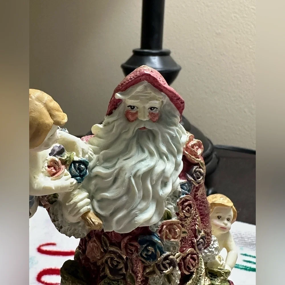 Festive Santa Figurine with Cherubs